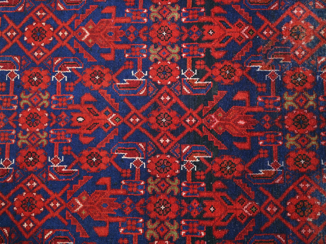 a red and blue rug with a design on it