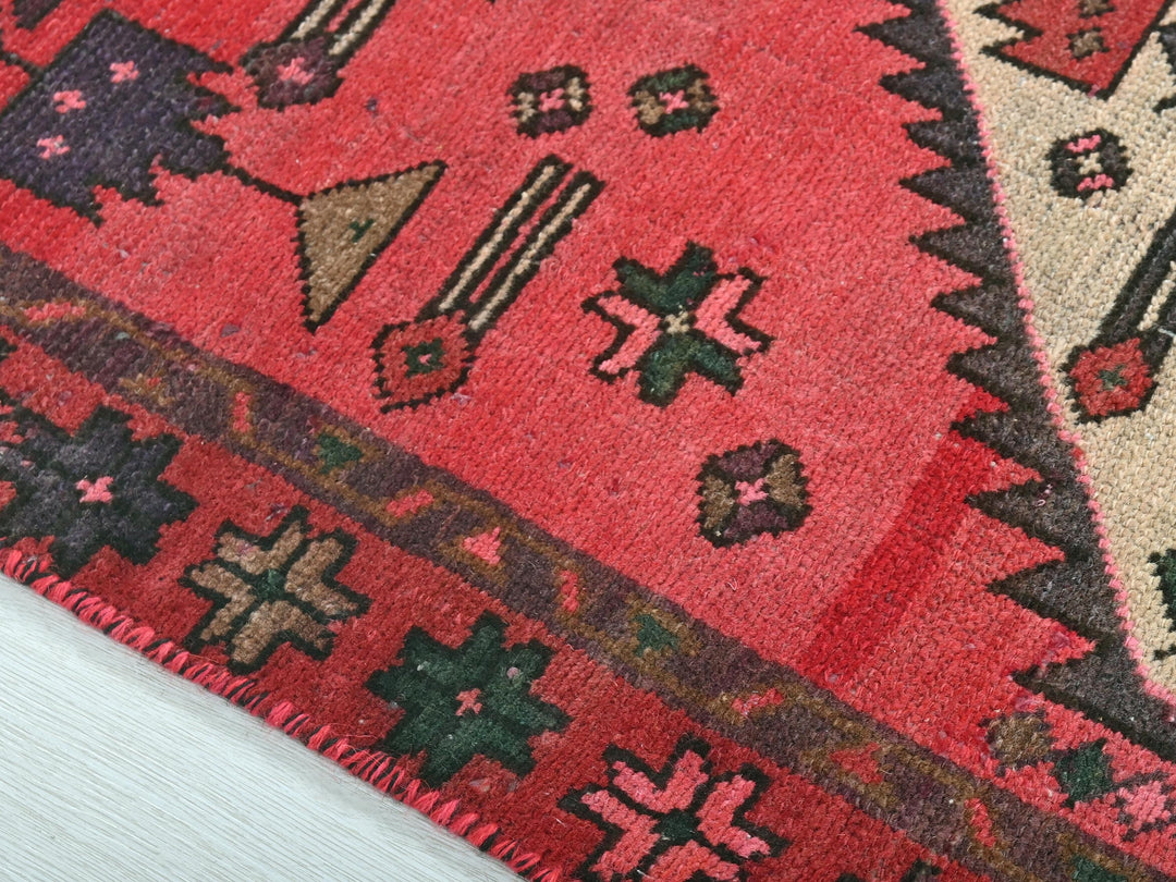a close up of a rug with a red background