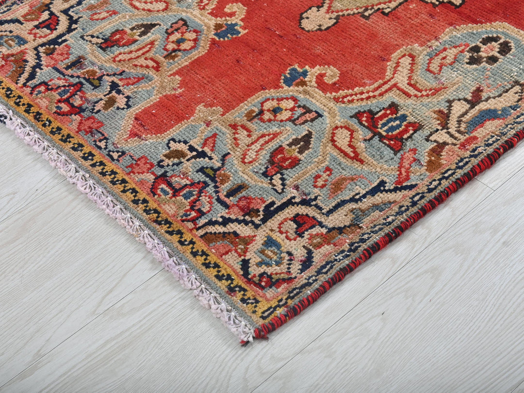 a red rug on a white wooden floor