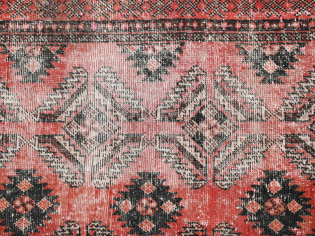 a close up of a red and black rug