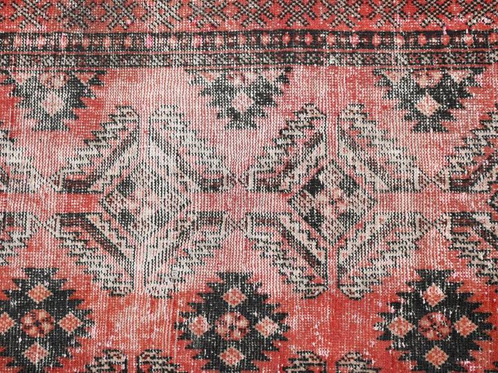 a close up of a red and black rug