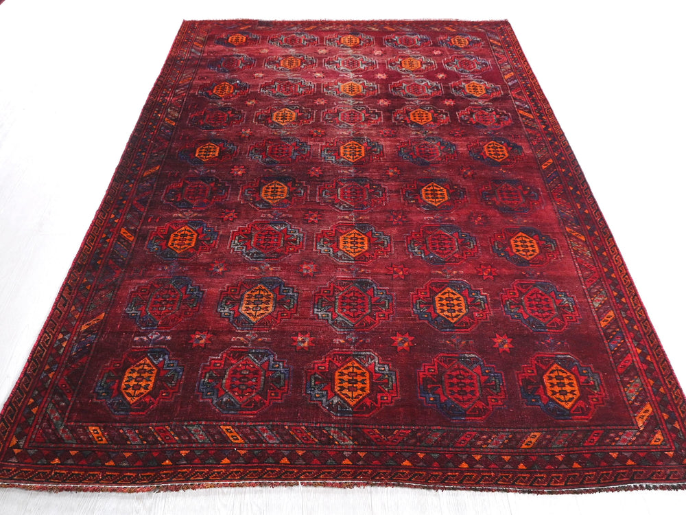a red rug with a design on the middle of it