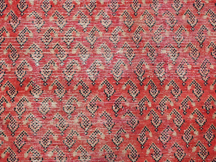 a close up of a red and black rug