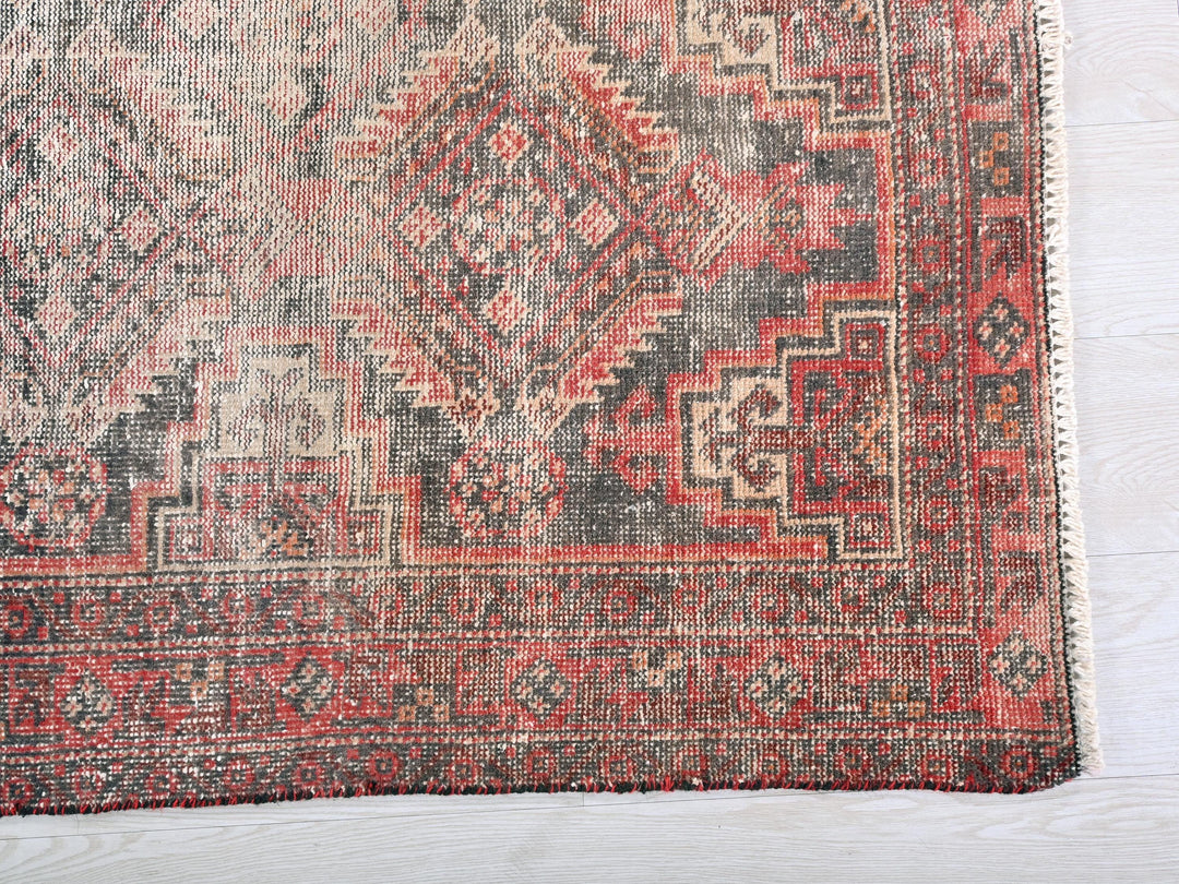 a red rug with a pattern on the middle of it