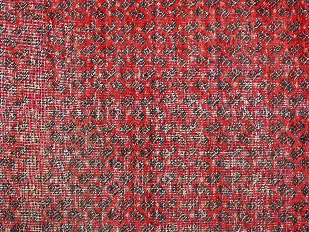 a close up of a red and black rug