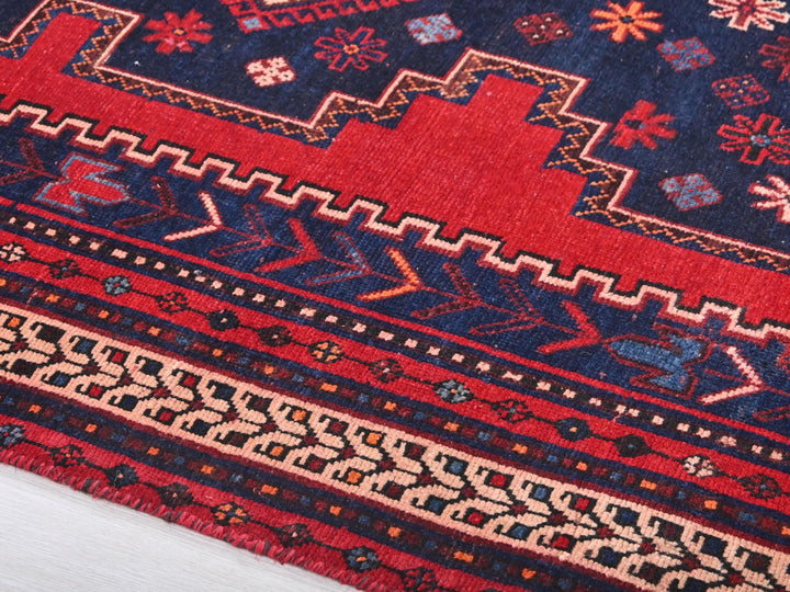 a close up of a red and blue oriental rug
