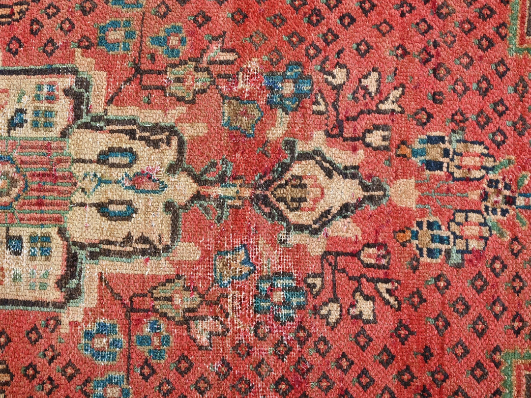 an old oriental rug with a red background