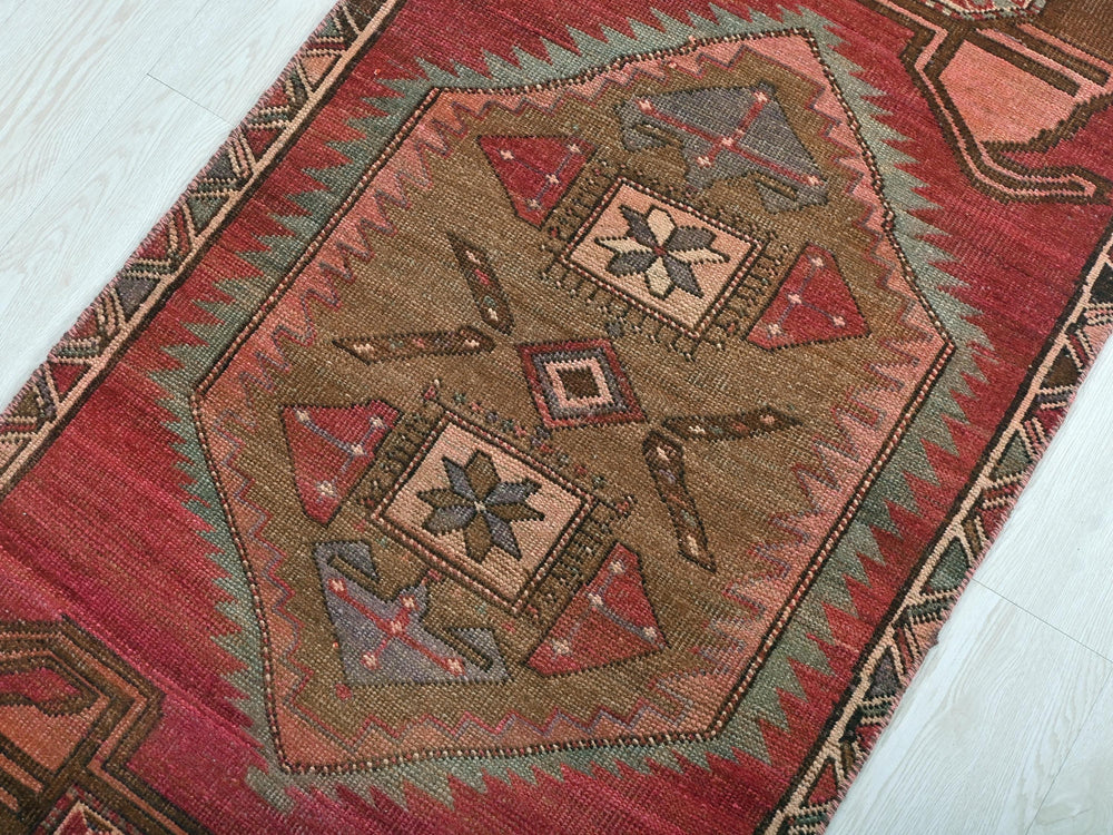 a red rug with a design on it