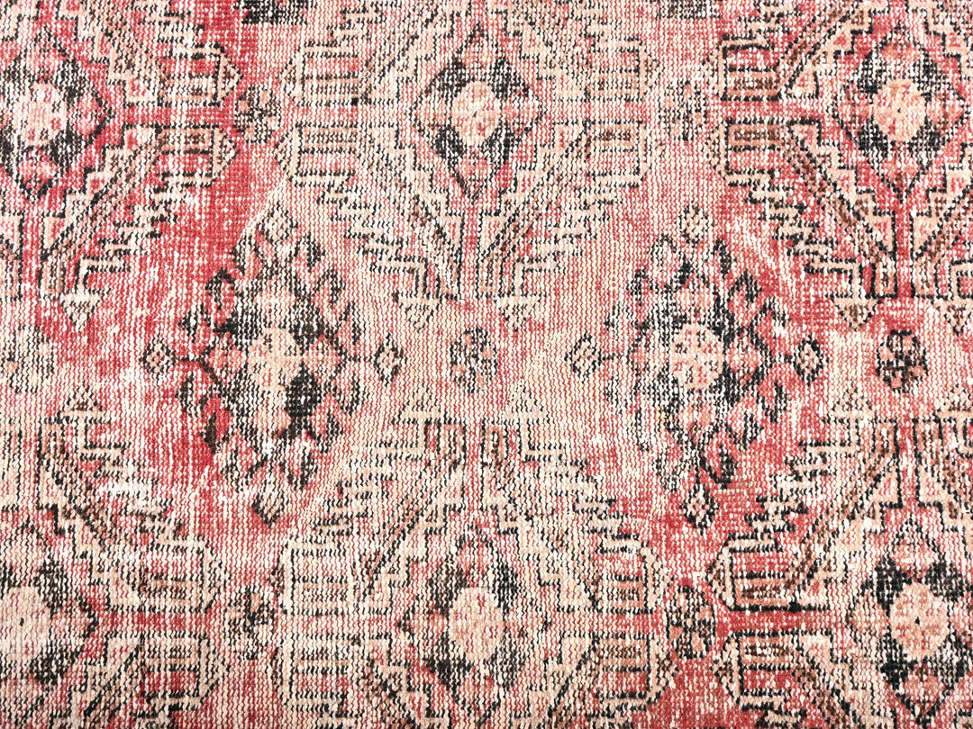a red and black rug with a pattern on it