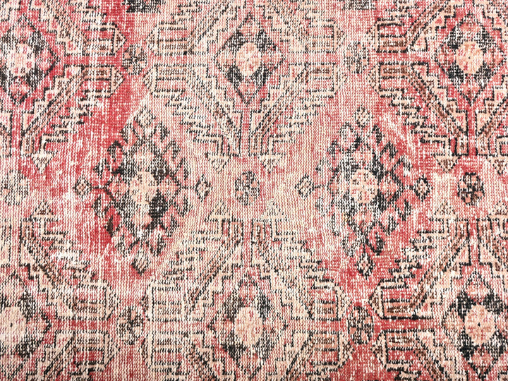 a red and black rug with a pattern on it