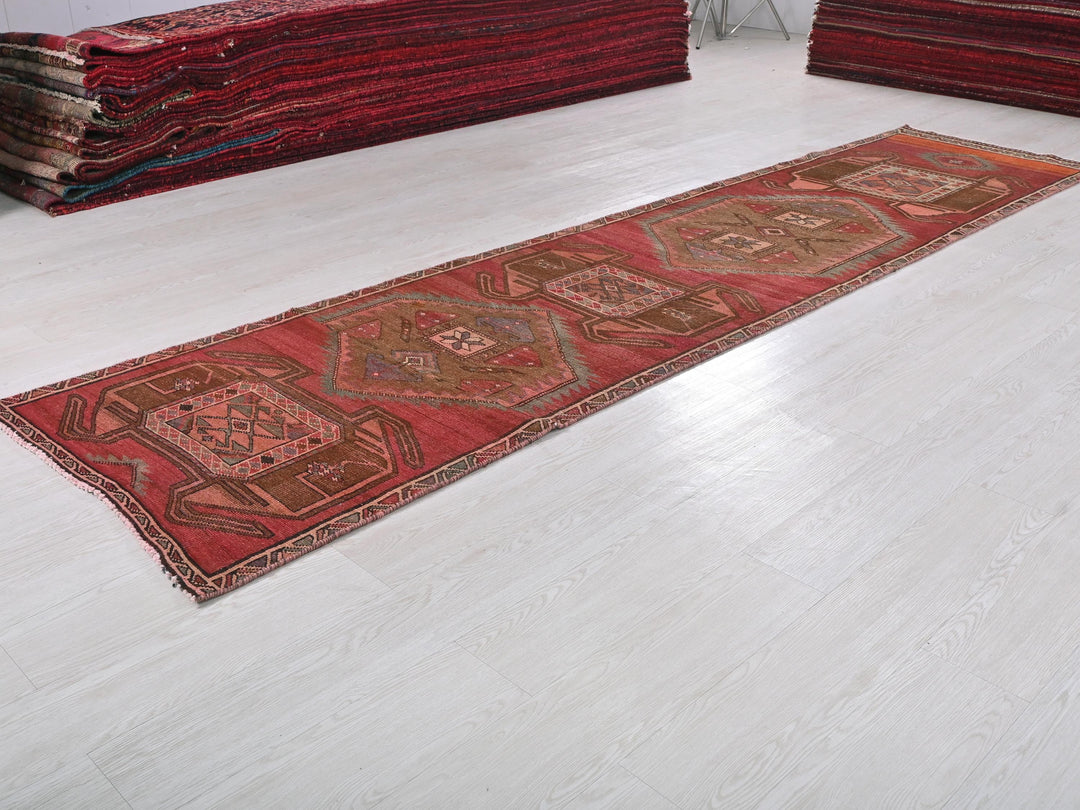 a pile of red rugs sitting on top of a white floor