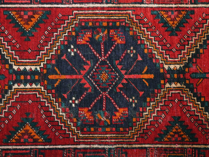 a red and blue rug with a pattern on it