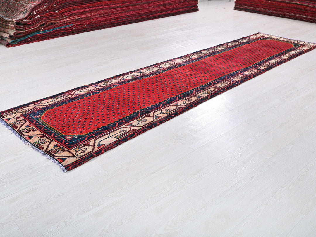 a red rug is laying on a white floor