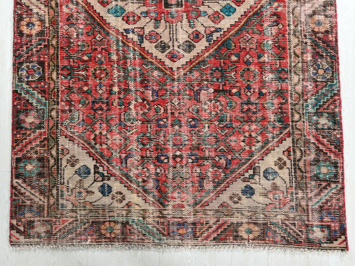 a red and blue rug on a white floor
