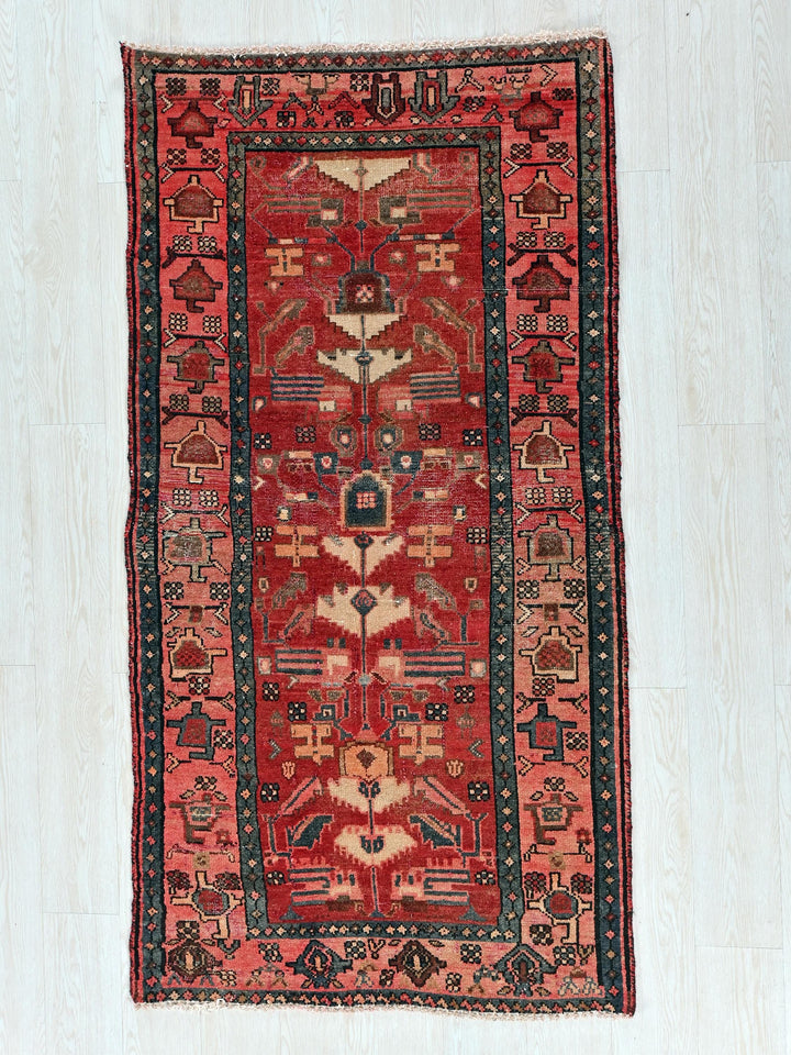a red and black rug on a white floor