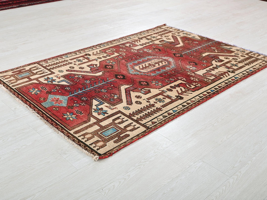 a red and beige rug on a white floor