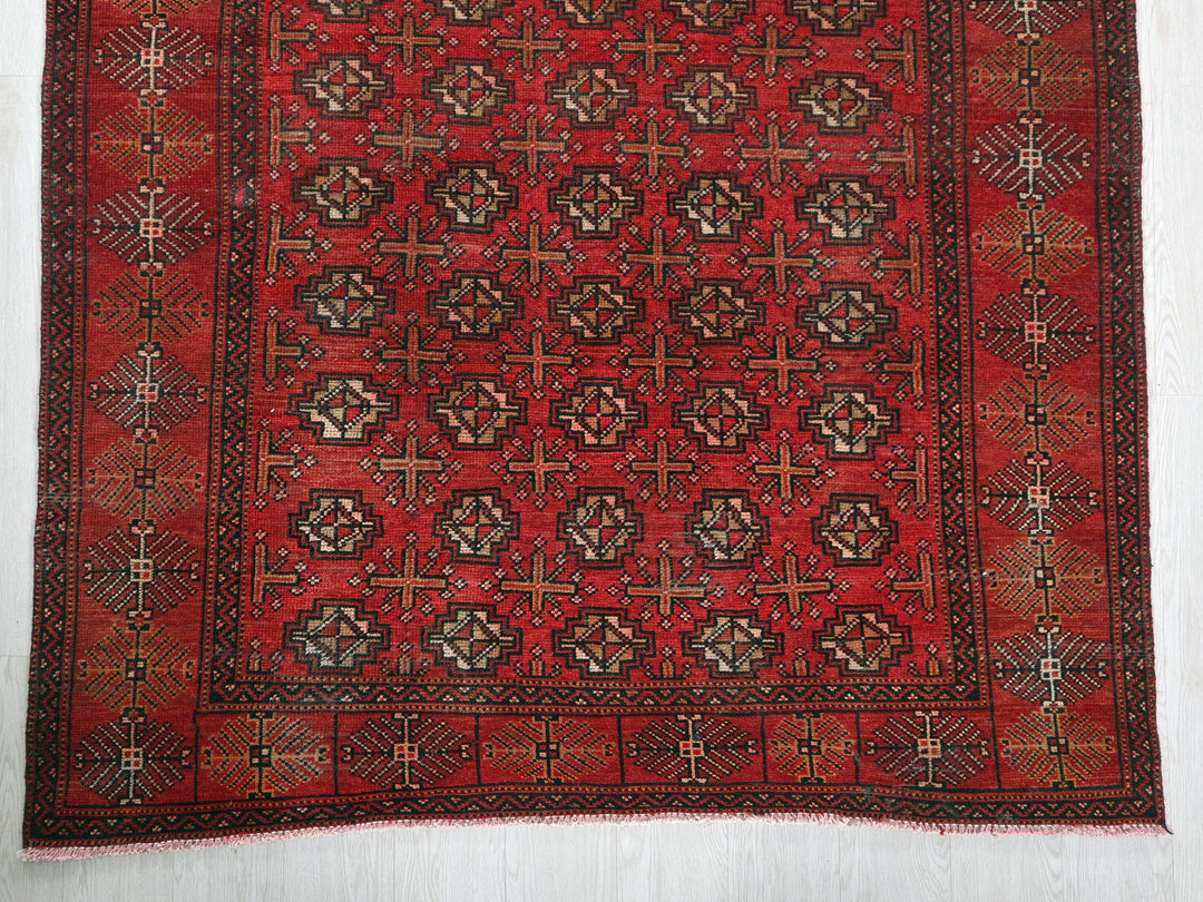 a red rug with a design on it