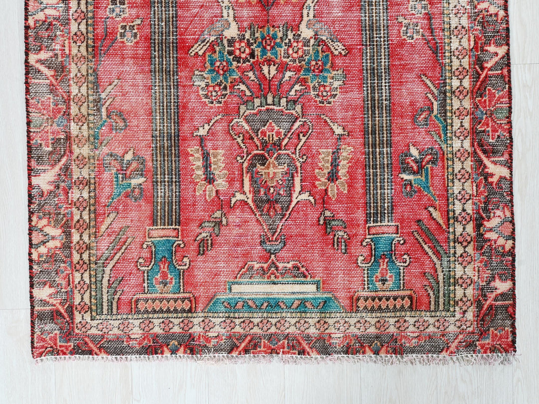 a red rug with an ornate design on it