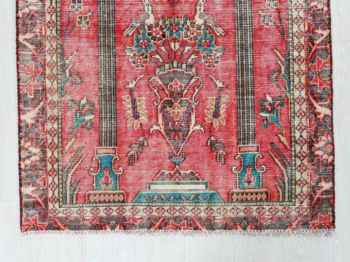 a red rug with an ornate design on it