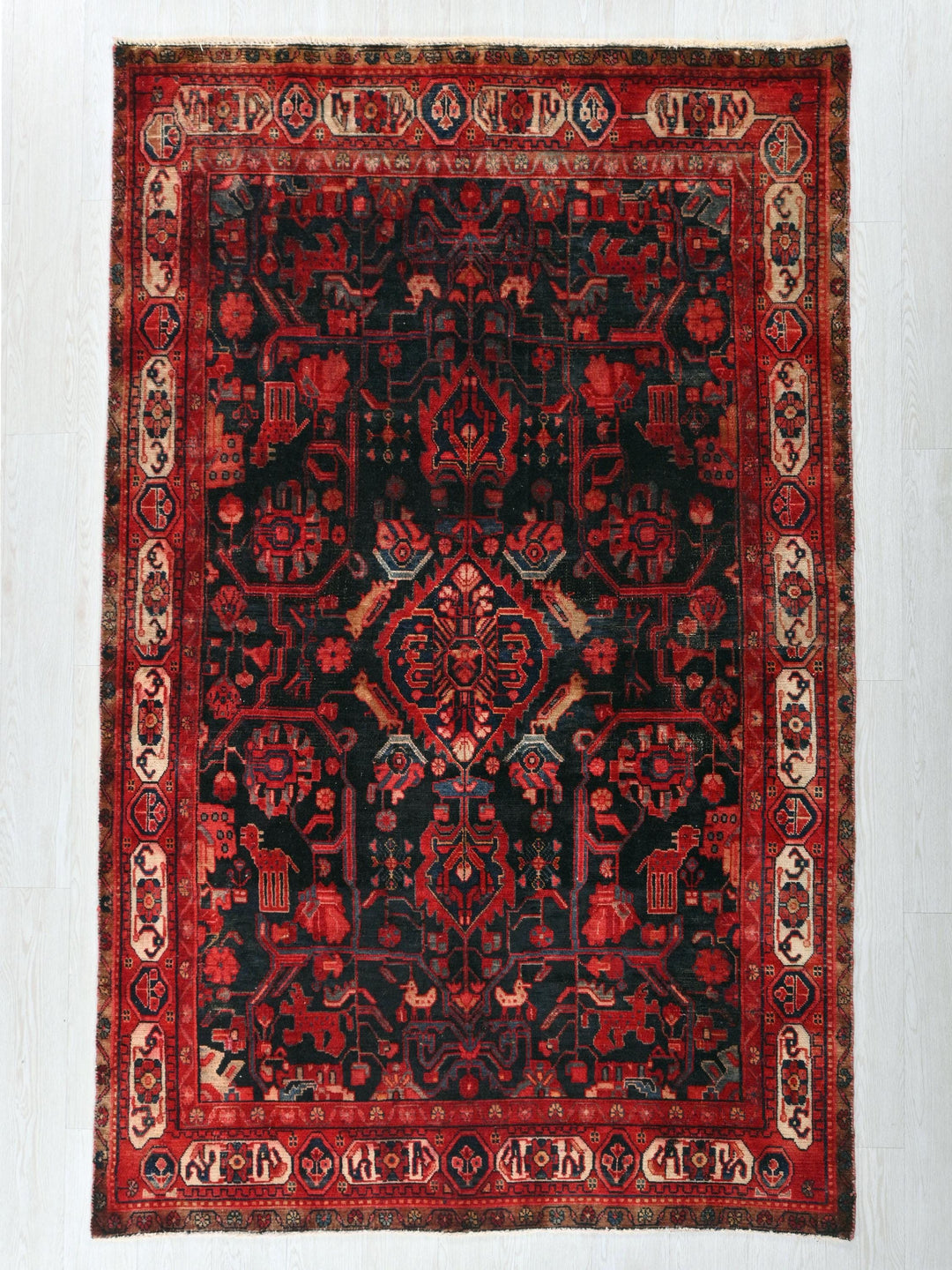 a red and black rug on a white wall