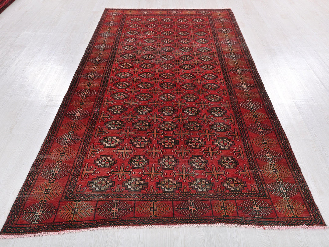 a red oriental rug on a white floor