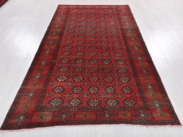 a red oriental rug on a white floor