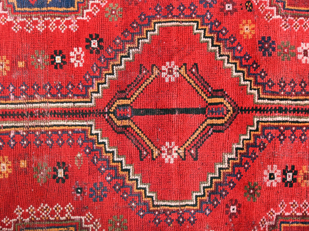 a close up of a red oriental rug