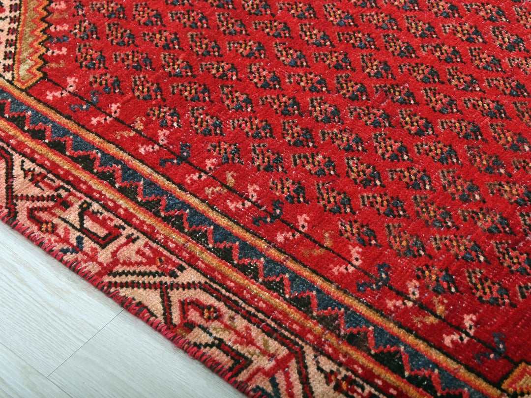 a close up of a red rug on the floor