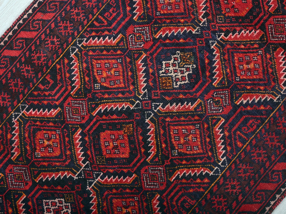 a close up of a red and black oriental rug
