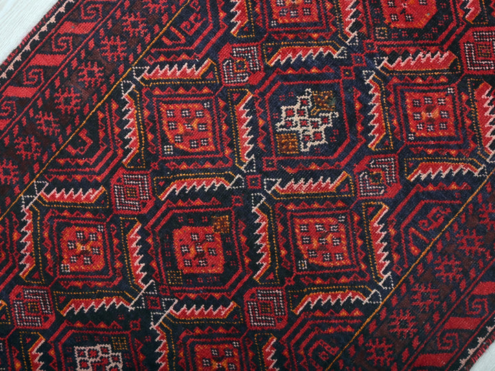 a close up of a red and black oriental rug