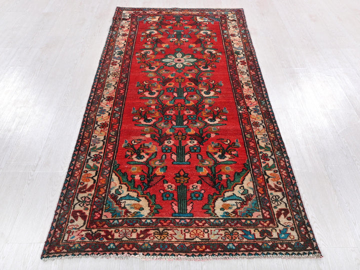 a red rug on a white wooden floor