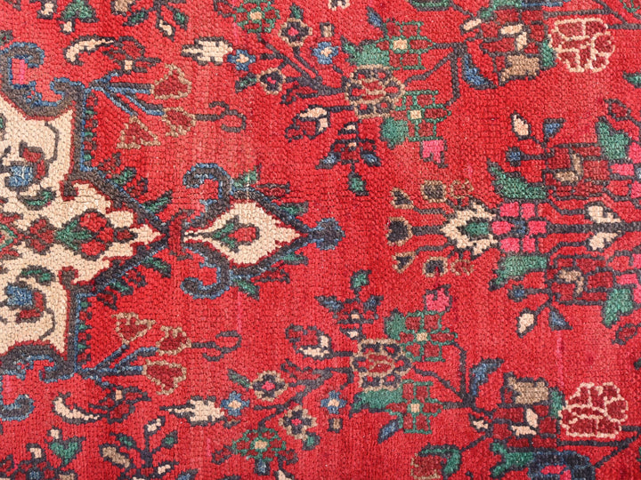 a red rug with a floral design on it