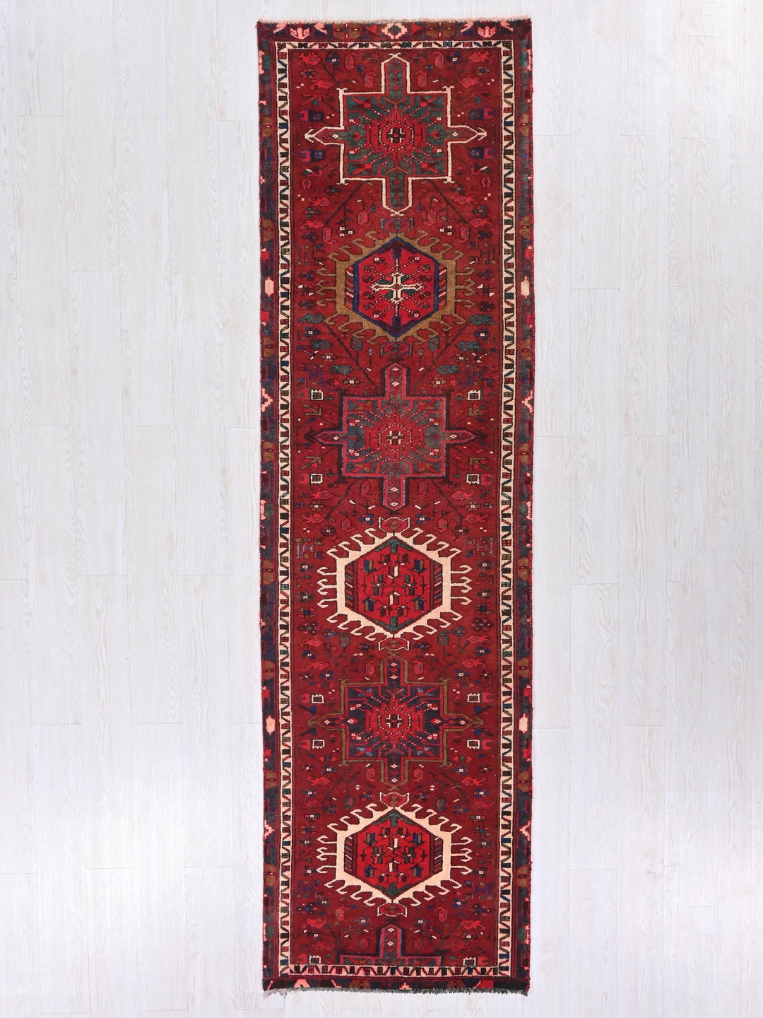 a red rug hanging up against a wall