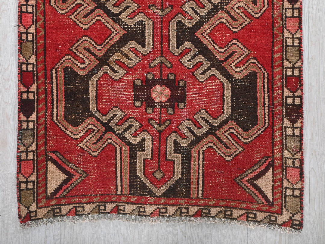 a red rug with a design on it