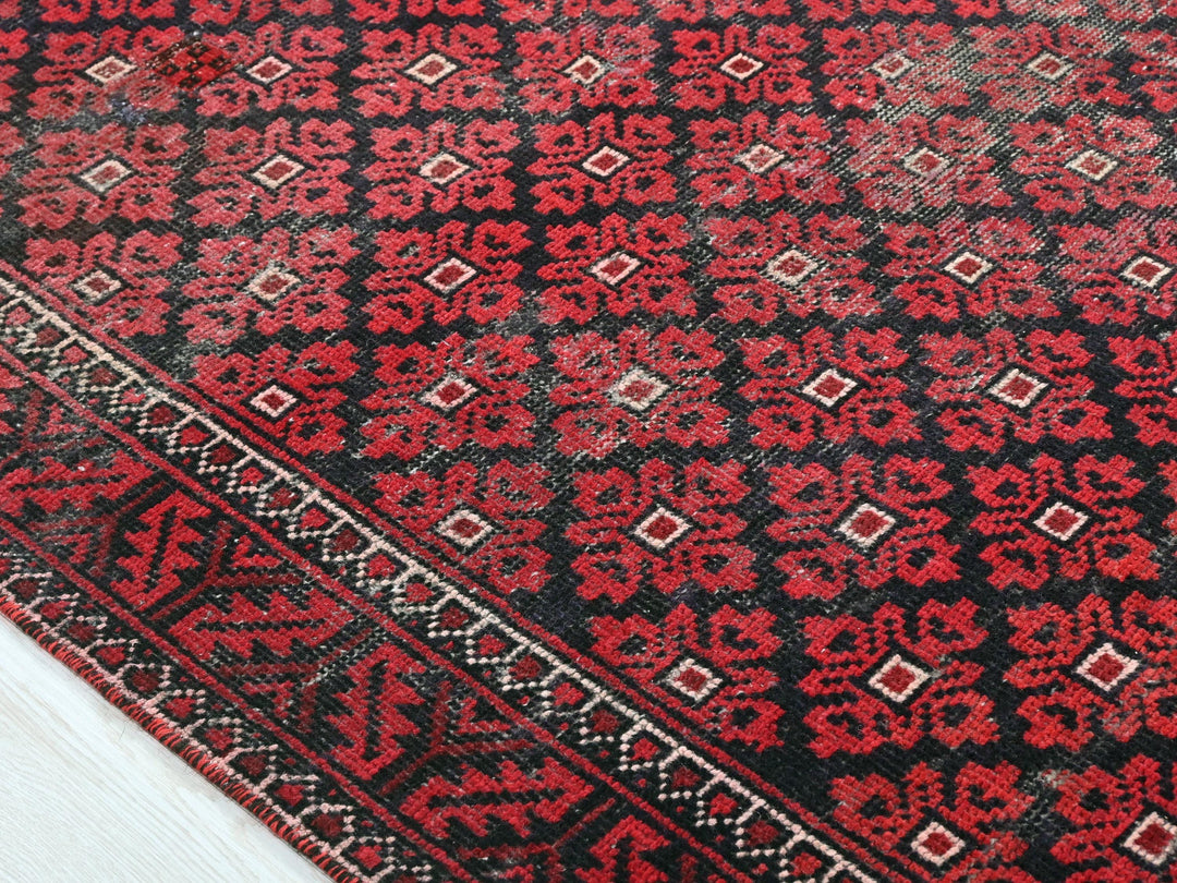 a close up of a red and black oriental rug