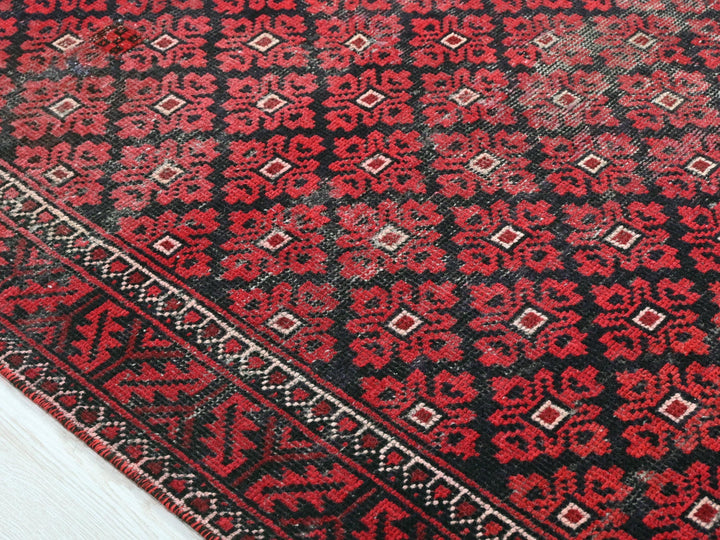 a close up of a red and black oriental rug