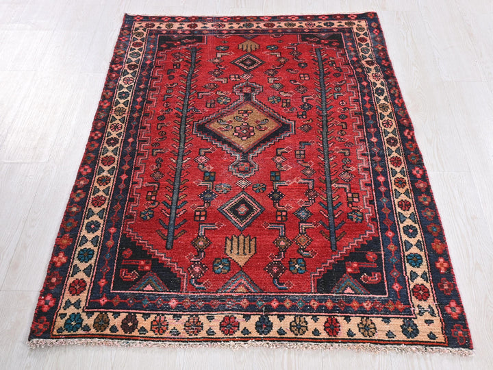 a red rug on a white wooden floor