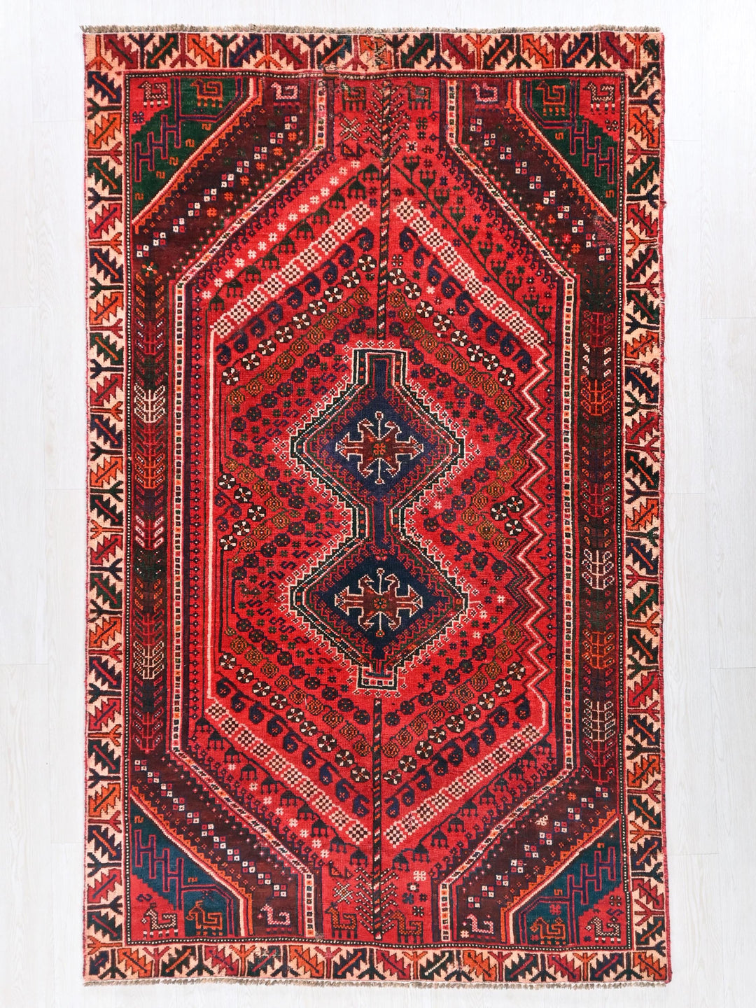 a red rug with a diamond shaped design