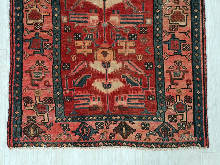 a red rug with a black border on a white background