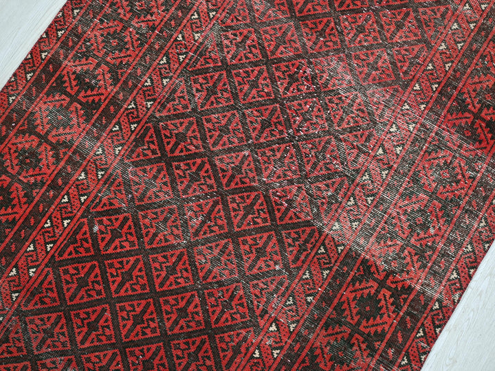 a close up of a red and black area rug