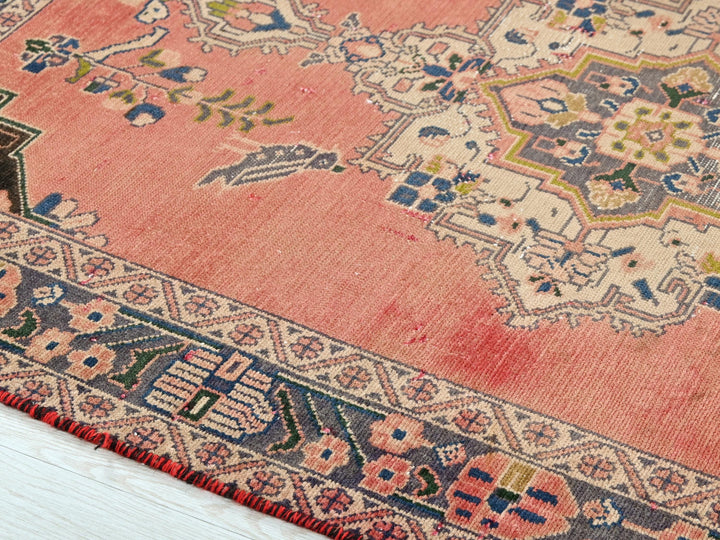 a pink rug with a floral design on it