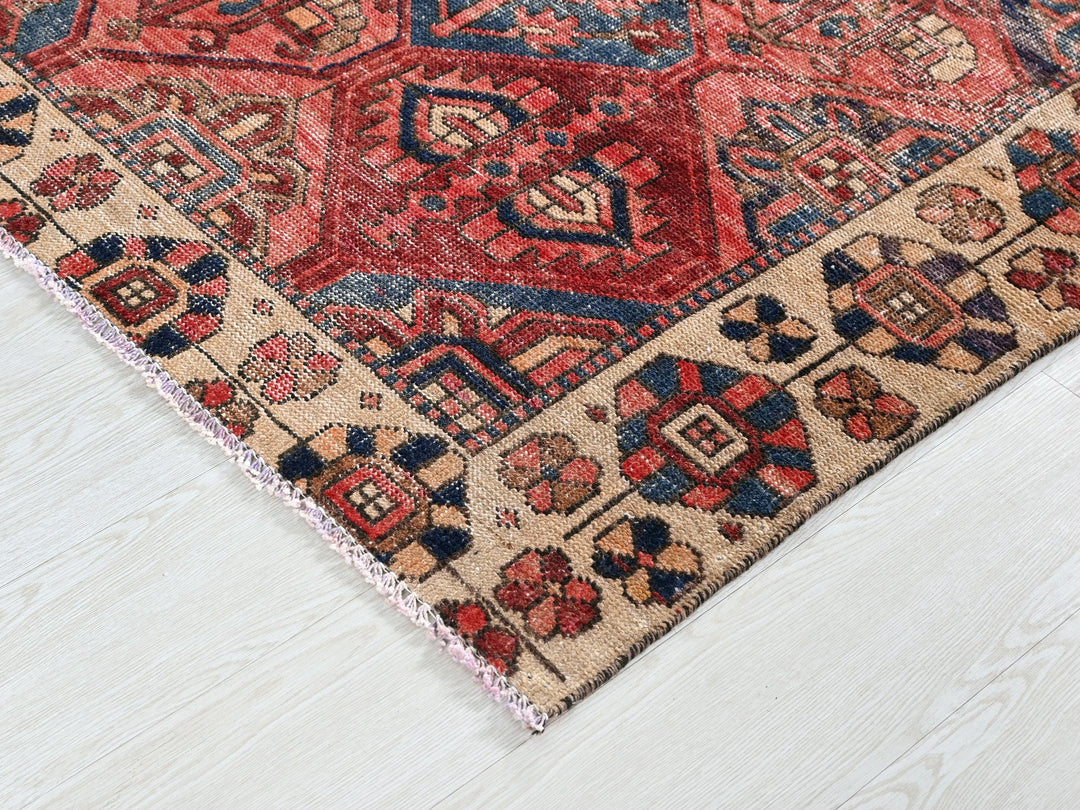 a red and blue rug on a white floor