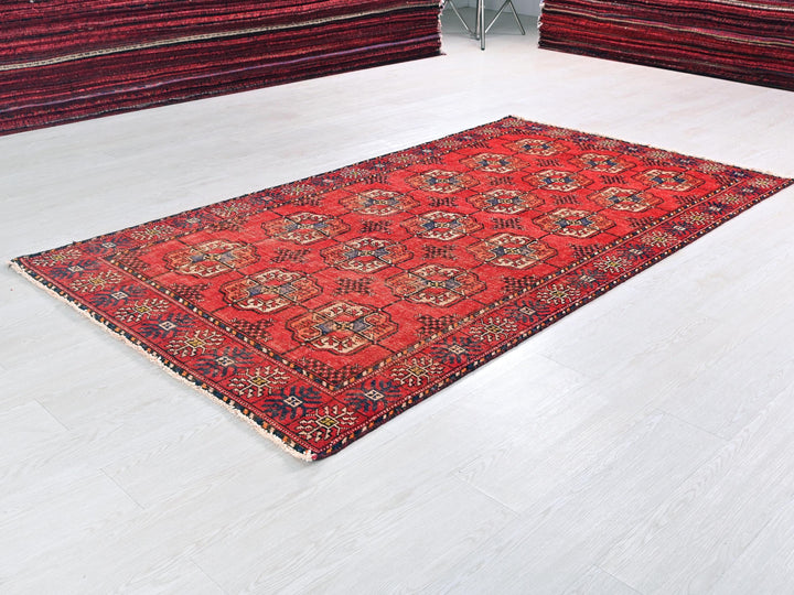 a red rug on a white floor in a room
