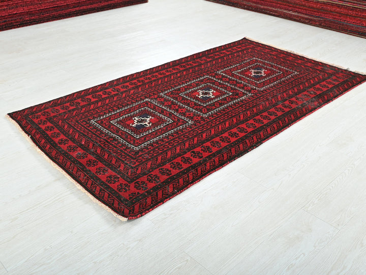 a red area rug on a white floor