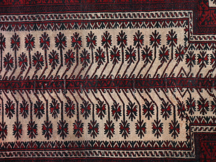 a close up of a red and black rug