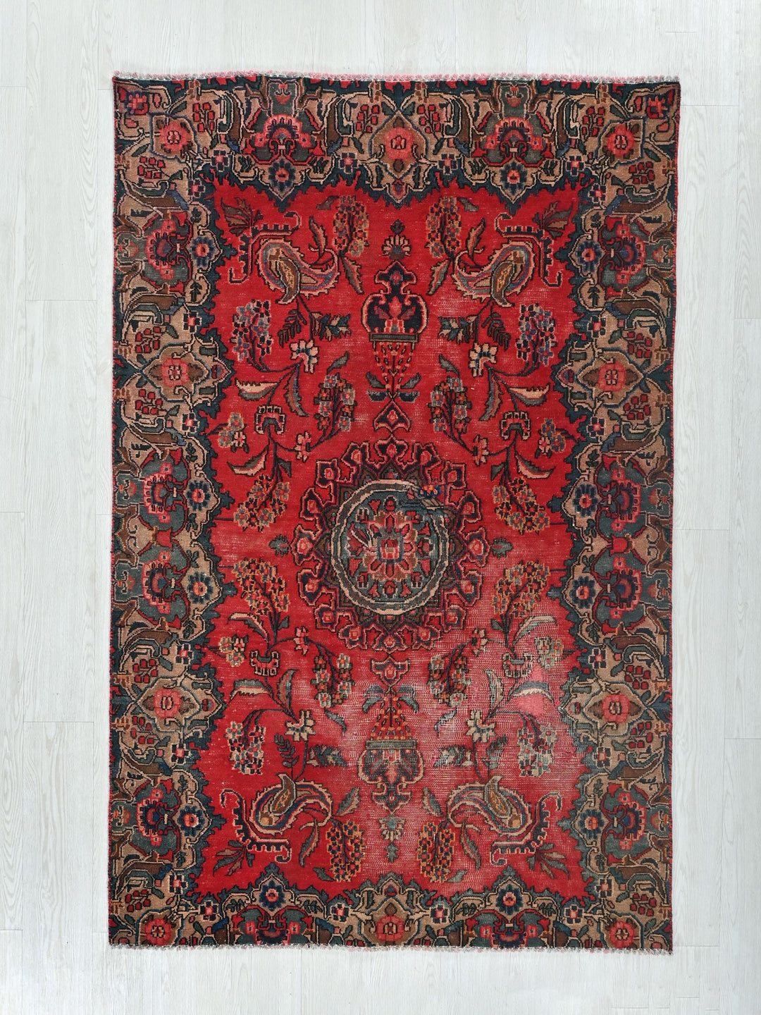 a red rug with a circular design on it