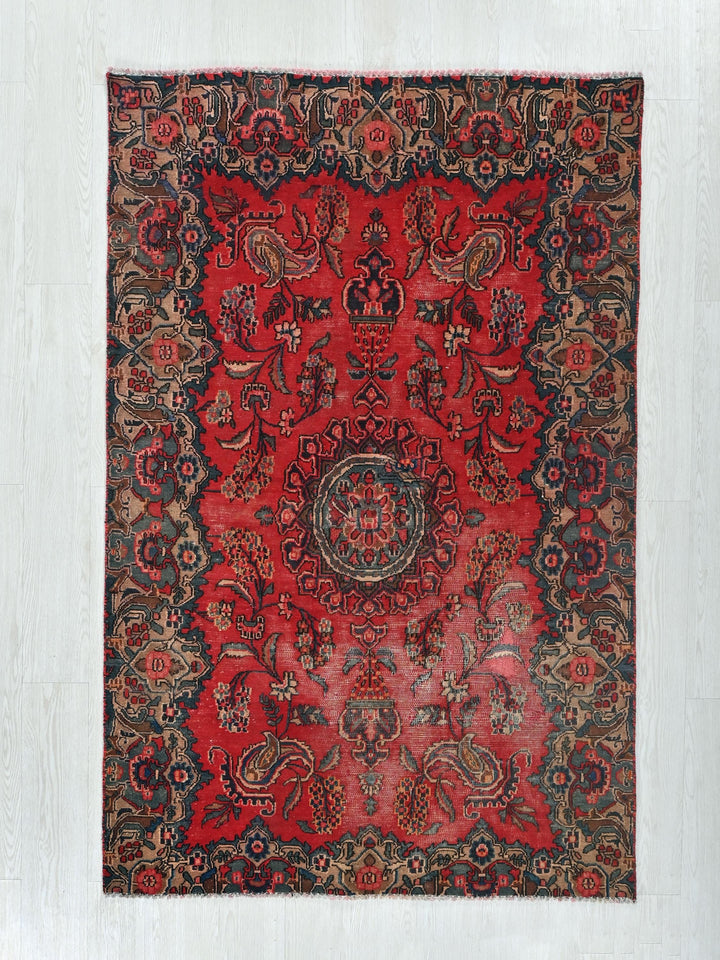 a red rug with a circular design on it