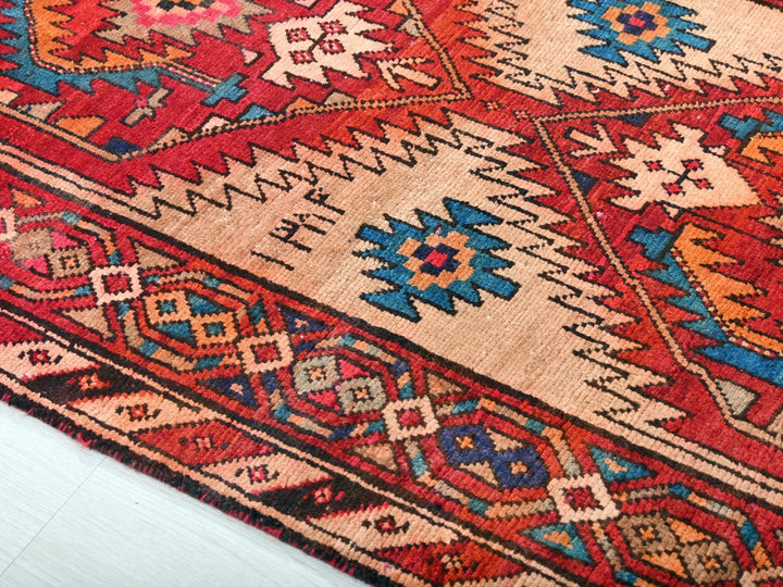 a red rug with a colorful design on it