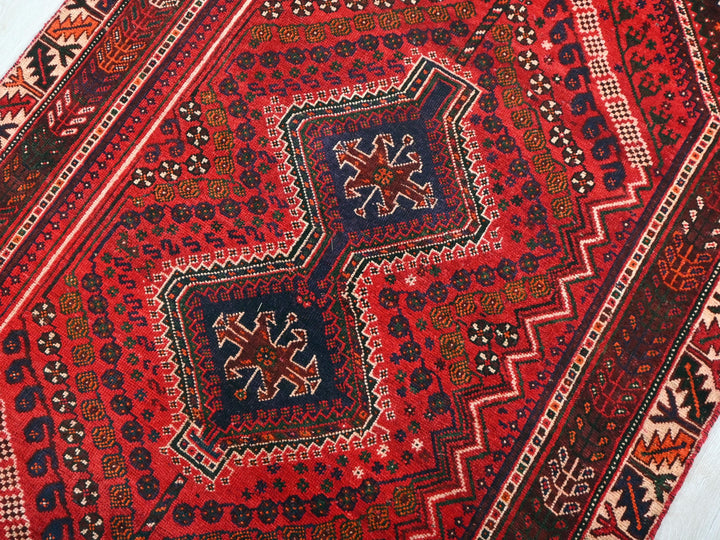 a close up of an oriental rug on the ground