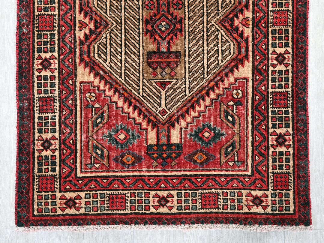 a red rug with a design on it